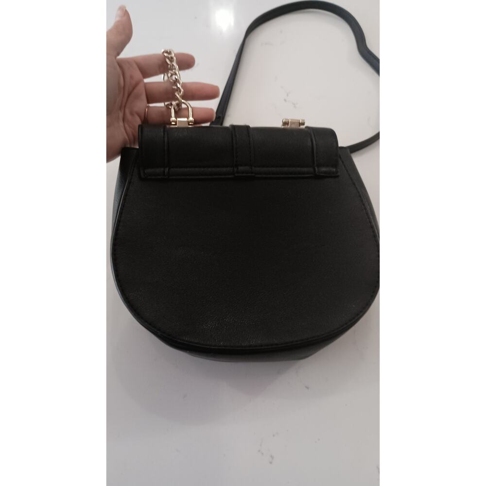 The Express Black Crossbody embellished with Bow metal grommets flap  closure. - Picture 7 of 12